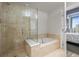 Bathroom featuring a walk-in glass shower and separate soaking tub at 2001 Lincoln St # 2420, Denver, CO 80202
