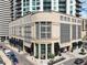Exterior shot of a modern building with large glass windows and awnings, adjacent to a street at 2001 Lincoln St # 2420, Denver, CO 80202