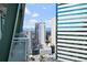 Downtown city view with a gray balcony and steel beams overlooking city skyscrapers on a sunny day at 2001 Lincoln St # 2420, Denver, CO 80202