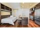 Open kitchen with island seating, integrated murphy bed, hardwood floors, and stainless appliances at 2001 Lincoln St # 2420, Denver, CO 80202