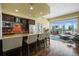 Modern kitchen with breakfast bar, stainless steel appliances, tile backsplash, and open layout to the living area at 2001 Lincoln St # 2420, Denver, CO 80202