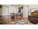 Open kitchen with stainless appliances, a central island with bar seating, and warm-toned hardwood flooring at 2001 Lincoln St # 2420, Denver, CO 80202