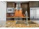 Close-up of kitchen features including stainless steel appliances, tile backsplash, and granite countertops at 2001 Lincoln St # 2420, Denver, CO 80202