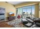 Cozy living room featuring a leather sofa, city views from large windows, and warm, patterned rug at 2001 Lincoln St # 2420, Denver, CO 80202