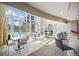 Bright lounge with bar, tables, chairs and swimming pool access through floor to ceiling glass doors at 2001 Lincoln St # 2420, Denver, CO 80202