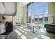 Bright lounge area with floor to ceiling windows, tables, chairs, and a view of the swimming pool at 2001 Lincoln St # 2420, Denver, CO 80202