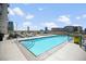 Rooftop pool with city views, lounge seating and adjacent hot tub at 2001 Lincoln St # 2420, Denver, CO 80202