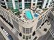 Aerial view of a rooftop pool and jacuzzi, surrounded by lounge chairs and tables at 2001 Lincoln St # 2420, Denver, CO 80202