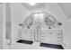 Bright bathroom with double sinks, large mirrors and white tile floors at 748 Elati St, Denver, CO 80204