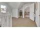 Upstairs hallway featuring neutral carpet, a chest of drawers and a peek into a closet at 748 Elati St, Denver, CO 80204