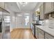 Bright kitchen with stainless steel appliances, light gray cabinetry, and ample counter space for meal preparation at 748 Elati St, Denver, CO 80204