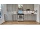 Updated kitchen featuring stainless steel appliances, grey cabinets, and subway tile backsplash for a modern look at 748 Elati St, Denver, CO 80204