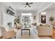 Bright, airy living room with stylish decor, painted brick fireplace, and large window offering pleasant views at 748 Elati St, Denver, CO 80204