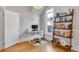 Bright home office with modern desk setup, decorative bookshelf, and comfortable workspace for productivity at 748 Elati St, Denver, CO 80204