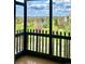Balcony with glass enclosure and views of the neighborhood golf course, buildings and landscaping at 13601 E Marina Dr # 604, Aurora, CO 80014