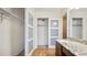 Bathroom features a granite countertop, a sink, and an open closet with translucent sliding doors at 13601 E Marina Dr # 604, Aurora, CO 80014