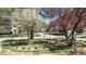 Well-maintained front yard with mature trees, lush landscaping, and a bench at 13601 E Marina Dr # 604, Aurora, CO 80014
