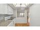 Kitchen with granite counters, white appliances, and a pass-through window to the living room at 13601 E Marina Dr # 604, Aurora, CO 80014