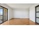 Living room with wood floors, and a sliding door to a balcony with lots of light at 13601 E Marina Dr # 604, Aurora, CO 80014