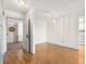 Bright living room with hardwood floors, modern lighting, and an open doorway, providing a welcoming space at 13601 E Marina Dr # 604, Aurora, CO 80014