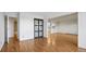 Living room with wood floors, door, and a view to the kitchen and other parts of the home at 13601 E Marina Dr # 604, Aurora, CO 80014