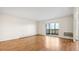 Bright living room with sliding glass doors leading to a balcony and gleaming hardwood floors at 13601 E Marina Dr # 604, Aurora, CO 80014