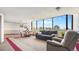 Relaxing living area with neutral colors, a dining area, and a large window with a view at 13601 E Marina Dr # 604, Aurora, CO 80014