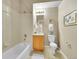 Well-lit bathroom featuring a bathtub with shower, a functional vanity, and a tiled floor at 16366 E Fremont Ave # 3, Aurora, CO 80016