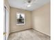 Bright bedroom with a ceiling fan, closet, and a window offering natural light and street views at 16366 E Fremont Ave # 3, Aurora, CO 80016