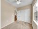Cozy bedroom featuring plush carpeting, closet and a glimpse into the home's elegant interior at 16366 E Fremont Ave # 3, Aurora, CO 80016