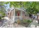 Charming condo exterior with a covered porch, brick accents, and lush landscaping, creating curb appeal at 16366 E Fremont Ave # 3, Aurora, CO 80016