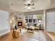 Bright living room with a fireplace, large windows, and hardwood flooring at 16366 E Fremont Ave # 3, Aurora, CO 80016