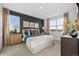 Comfortable bedroom with patterned accent wall and ample natural light at 43144 Kawana Gulch St, Elizabeth, CO 80107