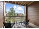 Relaxing balcony view with chair seating overlooking the community's common green space at 7440 S Blackhawk St # 205, Englewood, CO 80112
