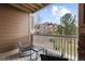 Private balcony with wood decking, chair seating, and views of surrounding property at 7440 S Blackhawk St # 205, Englewood, CO 80112