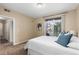 Bedroom featuring plush carpeting, balcony, and a view into the hallway and closet spaces at 7440 S Blackhawk St # 205, Englewood, CO 80112