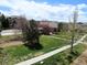 Scenic view of community lawn and walking path surrounded by mature trees at 7440 S Blackhawk St # 205, Englewood, CO 80112