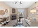 Bright living room featuring a cozy fireplace, stylish decor, and a sliding glass door to the patio at 7440 S Blackhawk St # 205, Englewood, CO 80112