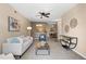 Bright living room leading to dining area and kitchen, featuring stylish decor and neutral colors at 7440 S Blackhawk St # 205, Englewood, CO 80112