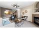 Cozy living room leading to the kitchen and dining area, with a comfortable sofa and fireplace at 7440 S Blackhawk St # 205, Englewood, CO 80112