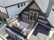 Cozy balcony area with seating, rug, and string lights on a house with black and gray accents at 2135 W 40Th Ave, Denver, CO 80211