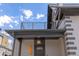 Balcony with an exterior light fixture and string lights on a building with brick walls at 2135 W 40Th Ave, Denver, CO 80211