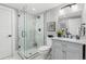 Modern bathroom featuring a glass shower door, marble walls, and decorative vanity at 2135 W 40Th Ave, Denver, CO 80211