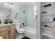 Bathroom featuring vanity, toilet, bathtub with shower, and decorative shelves at 2135 W 40Th Ave, Denver, CO 80211