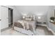 Cozy bedroom with neutral tones, plush bedding, side tables with lamps, and a sliding door closet at 2135 W 40Th Ave, Denver, CO 80211