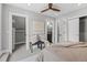 Bright bedroom with a ceiling fan, closet, and stylish bench seating with adjacent access to the bathroom at 2135 W 40Th Ave, Denver, CO 80211