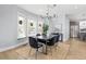 Dining room featuring modern chandelier, stainless steel refrigerator, and large windows at 2135 W 40Th Ave, Denver, CO 80211
