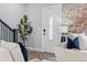 Entryway with a decorative front door, brick wall, and staircase with modern banister at 2135 W 40Th Ave, Denver, CO 80211