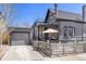 Side view of the house with a garage, patio, balcony, and fenced yard at 2135 W 40Th Ave, Denver, CO 80211