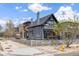 Gray two-story home with a fence, lovely landscaping, and a charming outdoor patio area at 2135 W 40Th Ave, Denver, CO 80211